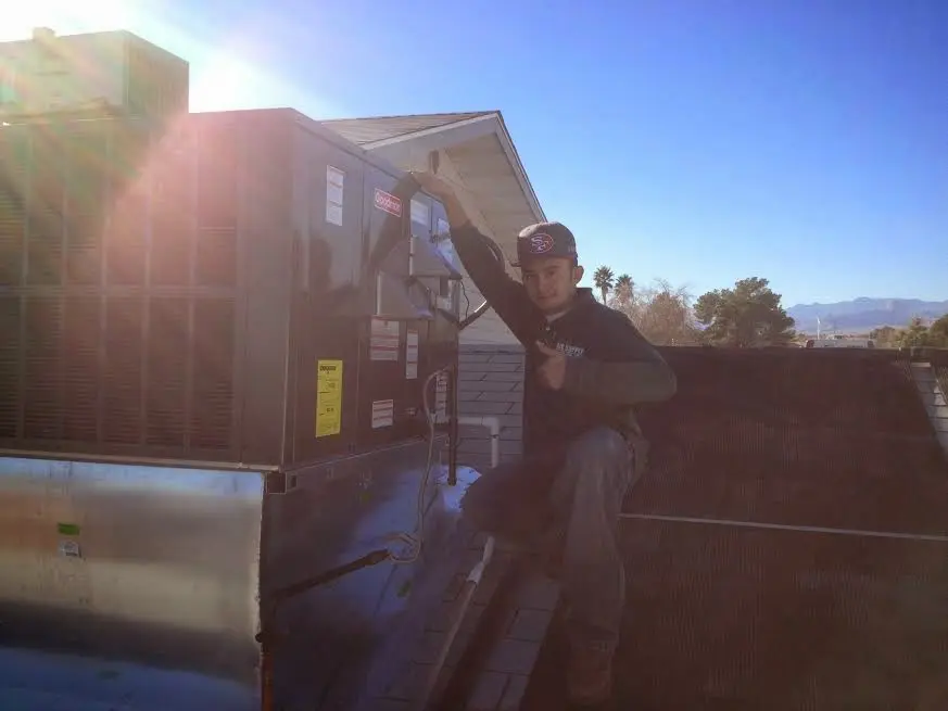 HVAC technician performing AC Tune-Up on a rooftop unit in Boyes Hot Springs